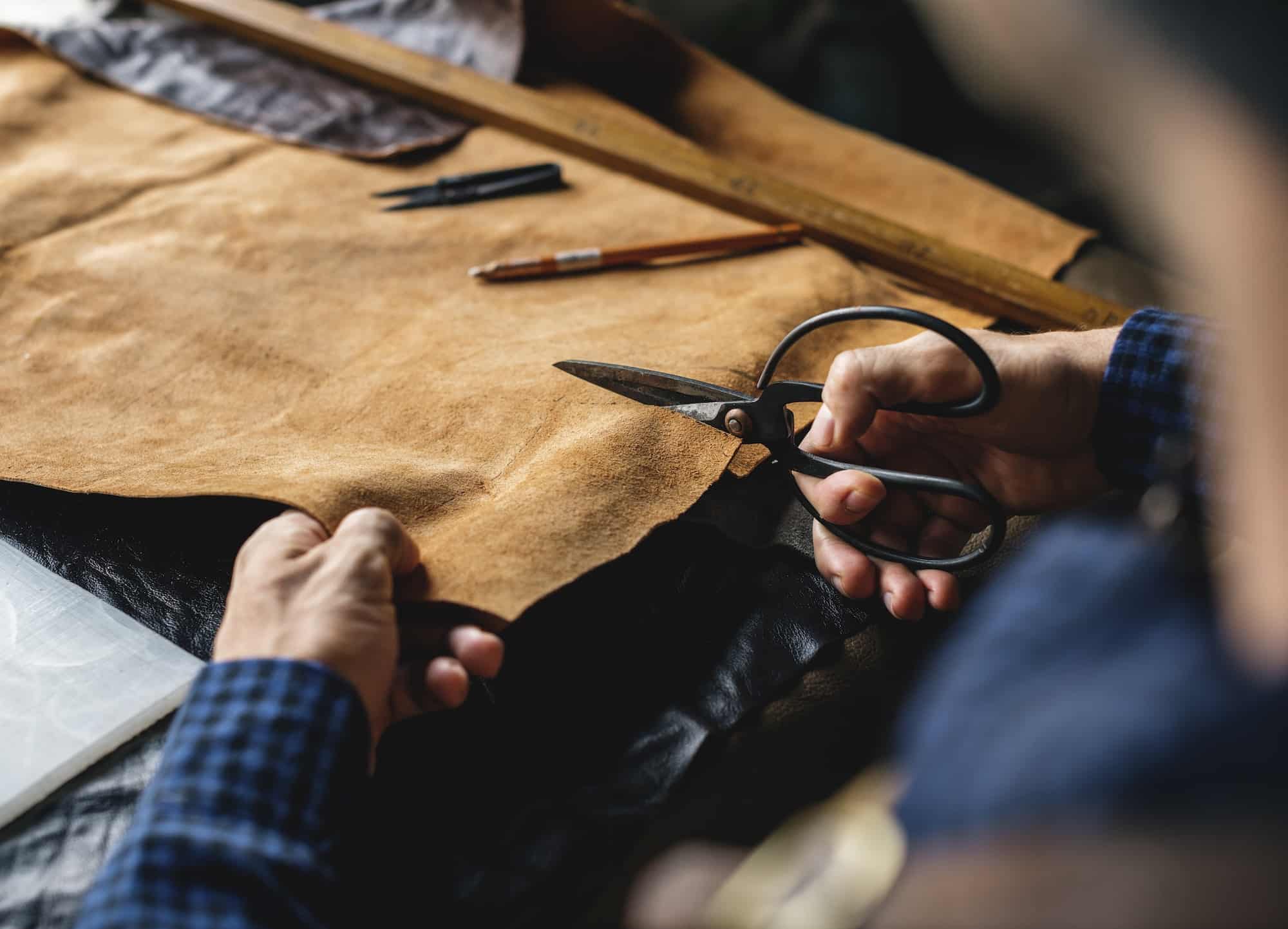closeup-of-craftsman-cutting-leather-handicraft.jpg