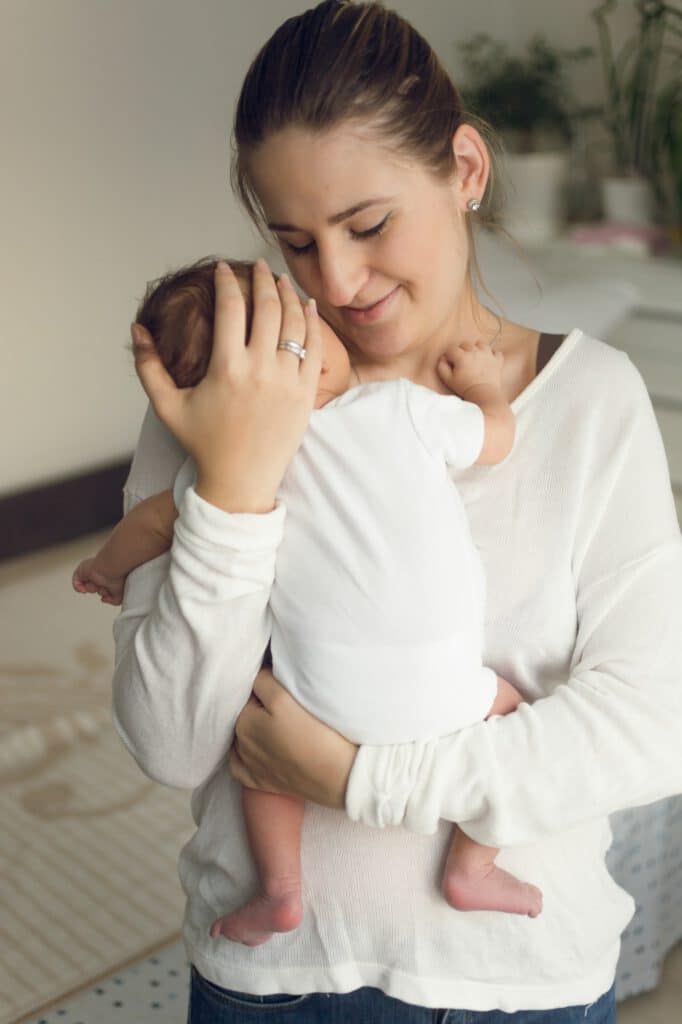 Portrait of happy mother holding newborn baby boy